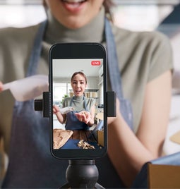 female chef filming herself making food on an online livestream