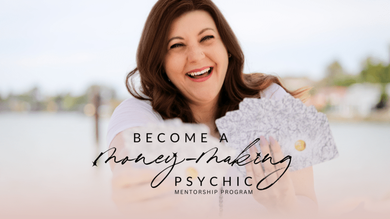 woman smiles holding henna patterned cards with black, ink-style text in forefront