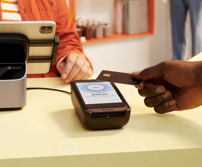 a hand placing a card against a terminal