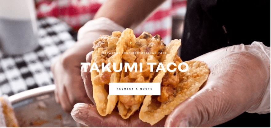 A close-up of a person holding a taco, a traditional Mexican dish made with a corn tortilla filled with seasoned meat, vegetables, and cheese.