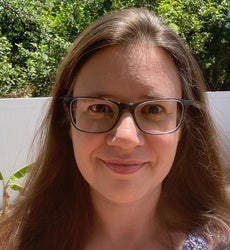 Smiling headshot of Michelle Kulas outside in the sun