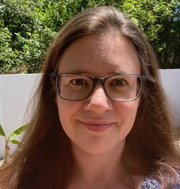 Smiling headshot of Michelle Kulas outside in the sun