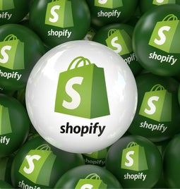 Green and white balls with Shopify logo on them