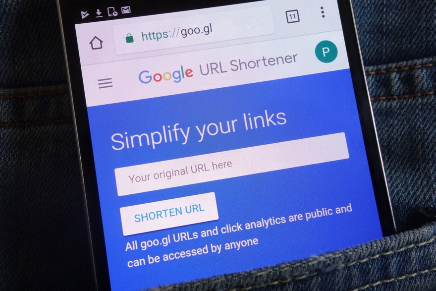 Phone in pocket showing the Google URL Shortener tool homepage