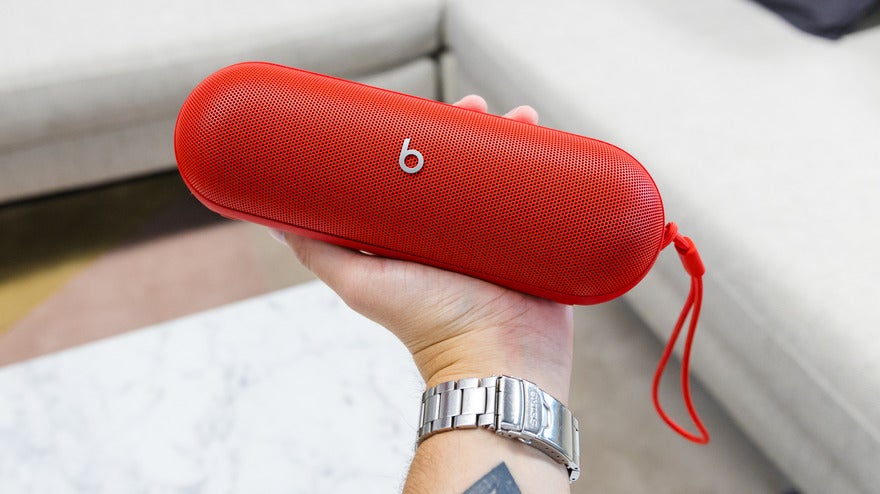 red beats pill speaker being held in a hand