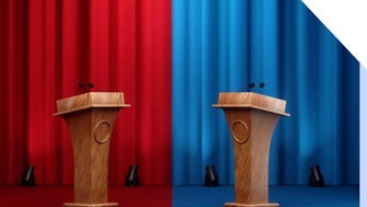 Photo of curtains with a red and blue side and podiums at each end